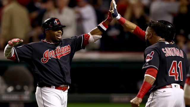 CLEVELAND, OH - NOVEMBER 02: Rajai Davis #20 of the Cleveland Indians celebrates with teammates after hitting a two-run home run during the eighth inning to tie the game 6-6 against the Chicago Cubs in Game Seven of the 2016 World Series at Progressive Field on November 2, 2016 in Cleveland, Ohio.