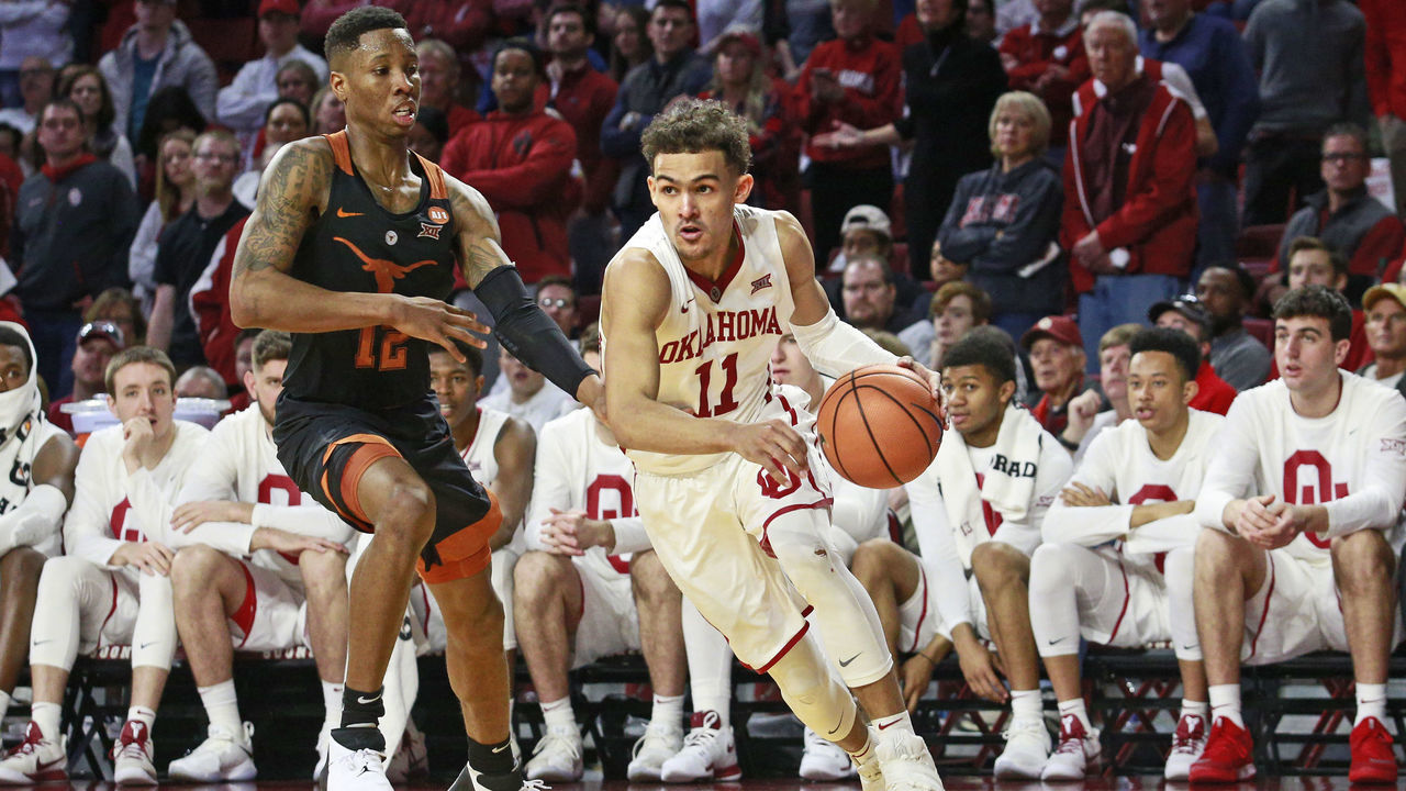NORMAN, OK - FEBRUARY 17: Trae Young #11 of the Oklahoma Sooners drives the baseline on Kerwin Roach II #12 of the Texas Longhorns at Lloyd Noble Center on February 17, 2018 in Norman, Oklahoma. The Longhorns defeated the Sooners 77-66.