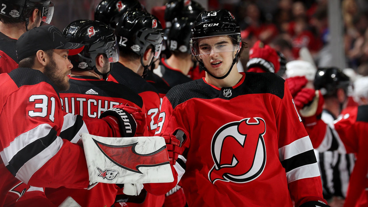 NEWARK, NJ - FEBRUARY 15: Nico Hischier #13 of the New Jersey Devils celebrates his goal with teammate Eddie Lack #31 as he skates by the bench in the third period against the Carolina Hurricanes on February 15, 2018 at Prudential Center in Newark, New Jersey.The New Jersey Devils defeated the Carolina Hurricanes 5-2.