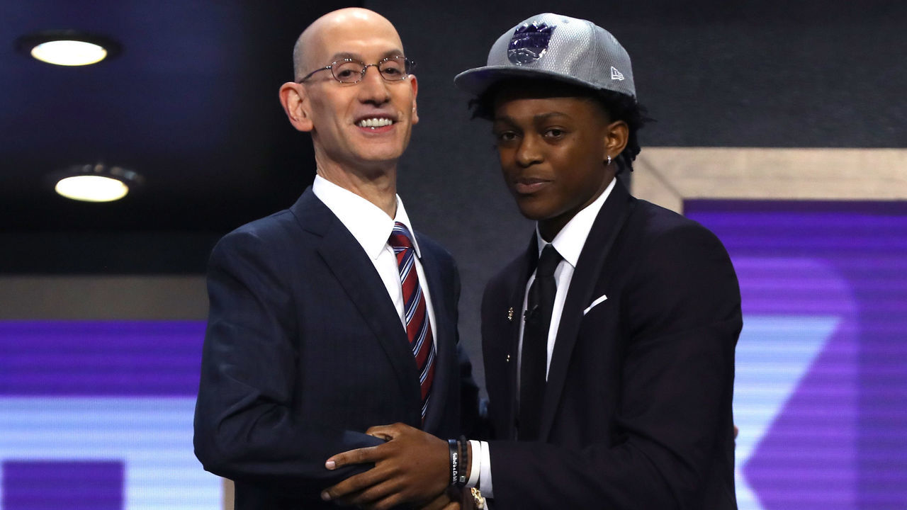 NEW YORK, NY - JUNE 22: DeAaron Fox walks on stage with NBA commissioner Adam Silver after being drafted fifth overall by the Sacramento Kings during the first round of the 2017 NBA Draft at Barclays Center on June 22, 2017 in New York City.
