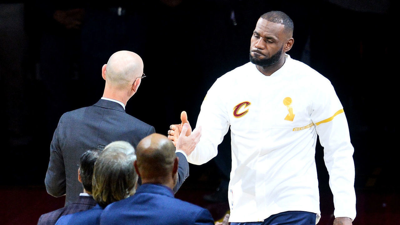 CLEVELAND, OH - OCTOBER 25: LeBron James #23 of the Cleveland Cavaliers receives his championship ring from NBA commissioner Adam Silver before the game against the New York Knicks at Quicken Loans Arena on October 25, 2016 in Cleveland, Ohio.