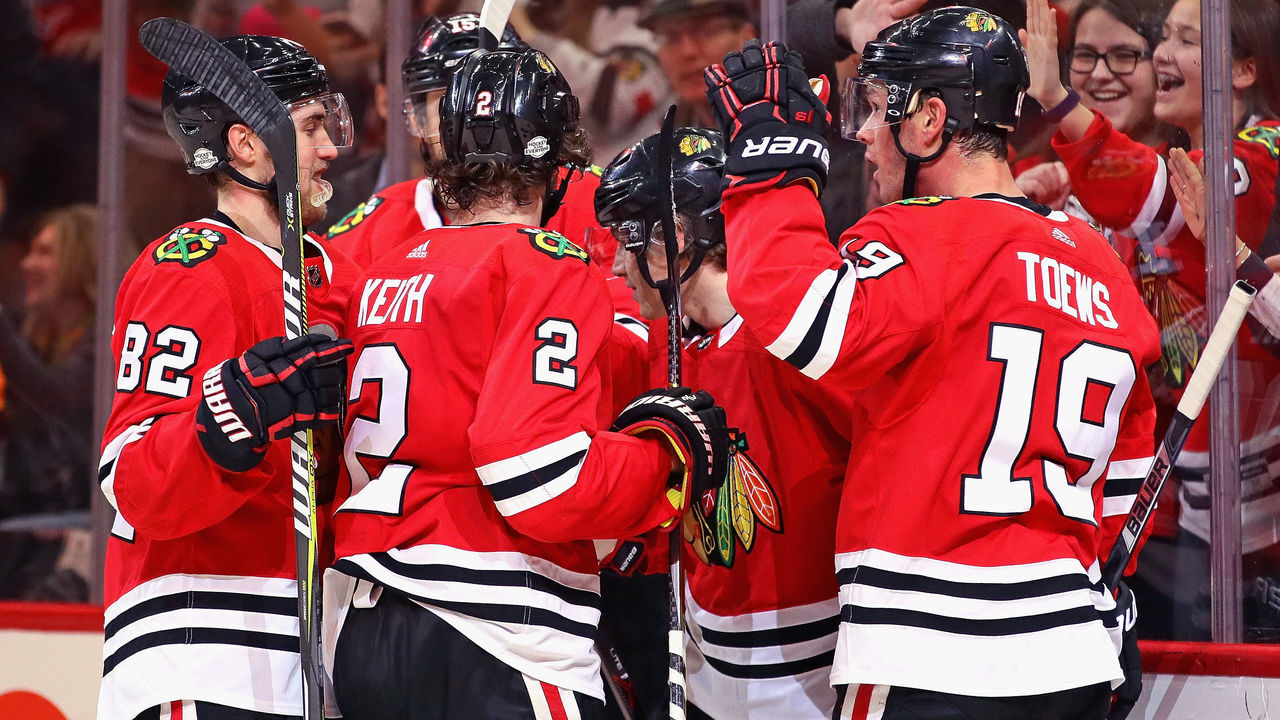 CHICAGO, IL - FEBRUARY 17: (L-R) Jordan Oesterle #82, Duncan Keith #2, Patrick Kane #88 and Jonathan Toews #19 of the Chicago Blackhawks celebrate a second period goal by Kane against the Washington Capitals at the United Center on February 17, 2018 in Chicago, Illinois.