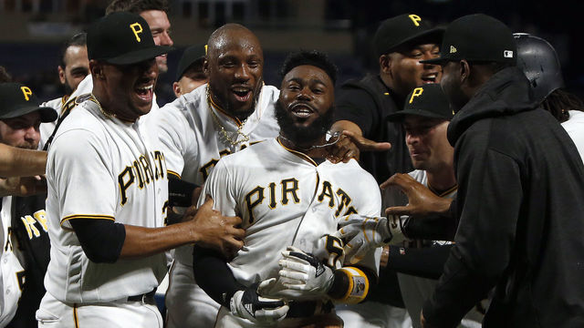 PITTSBURGH, PA - AUGUST 23: Josh Harrison #5 of the Pittsburgh Pirates celebrates with teammates after hitting a walk off home run in the tenth inning breaking up a no hitter against the Los Angeles Dodgers in the at PNC Park on August 23, 2017 in Pittsburgh, Pennsylvania.