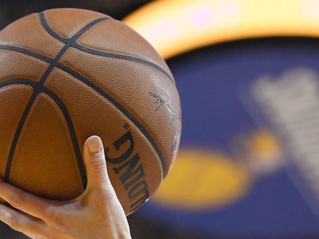 OAKLAND, CA - FEBRUARY 06: A detailed view ot the official Spalding NBA basketball held in the air by referee Lauren Holtkamp #7 during an NBA basketball game between the Oklahoma City Thunder and Golden State Warriors at ORACLE Arena on February 6, 2018 in Oakland, California.