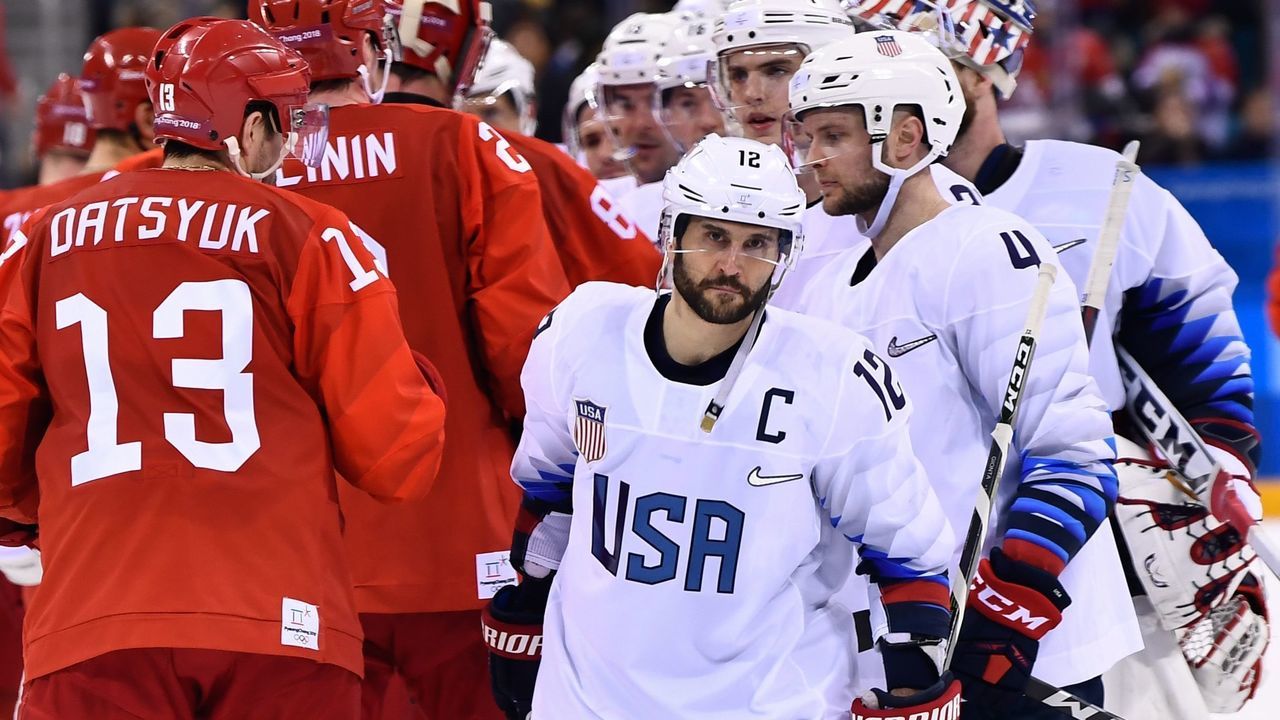 Players shake hands after the men's ice hockey preliminary round group B game between the Olympic Athletes from Russia and the United States during the Pyeongchang 2018 Winter Olympic Games at the Gangneung Hockey Centre in Gangneung on February 17, 2018. / AFP PHOTO / Brendan Smialowski
