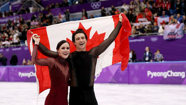 GANGNEUNG, SOUTH KOREA - FEBRUARY 20: Gold medal winners Tessa Virtue and Scott Moir of Canada celebrate during the victory ceremony for the Figure Skating Ice Dance Free Dance on day eleven of the PyeongChang 2018 Winter Olympic Games at Gangneung Ice Arena on February 20, 2018 in Gangneung, South Korea.