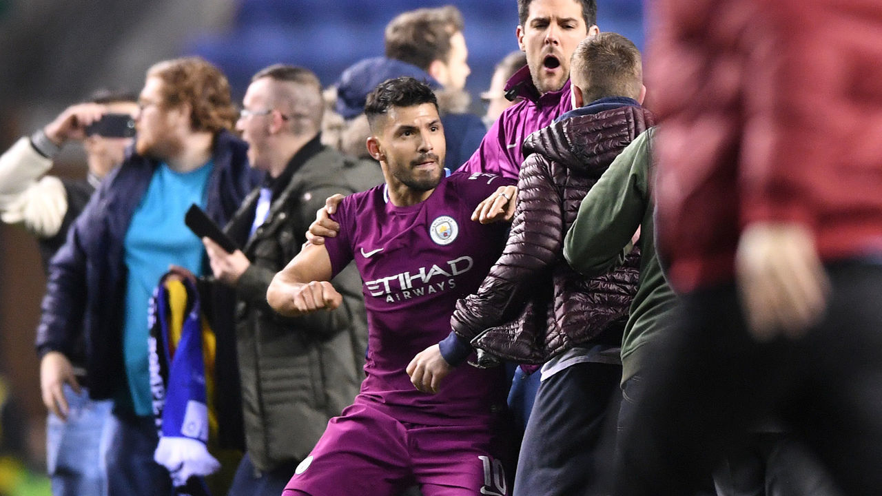 WIGAN, ENGLAND - FEBRUARY 19: Sergio Aguero of Manchester City is surrounded by fans as he attempts to leave the pitch after the Emirates FA Cup Fifth Round match between Wigan Athletic and Manchester City at DW Stadium on February 19, 2018 in Wigan, England.