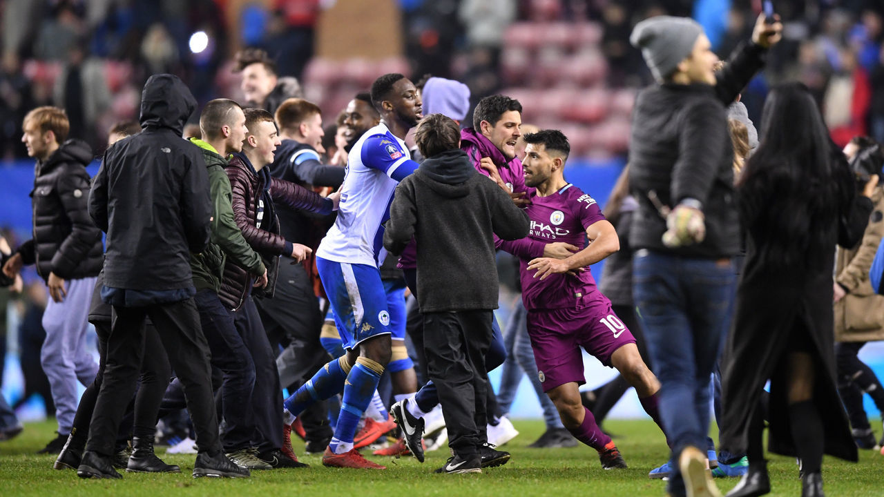 WIGAN, ENGLAND - FEBRUARY 19: Sergio Aguero of Manchester City is surrounded by fans as he attempts to leave the pitch after the Emirates FA Cup Fifth Round match between Wigan Athletic and Manchester City at DW Stadium on February 19, 2018 in Wigan, England.