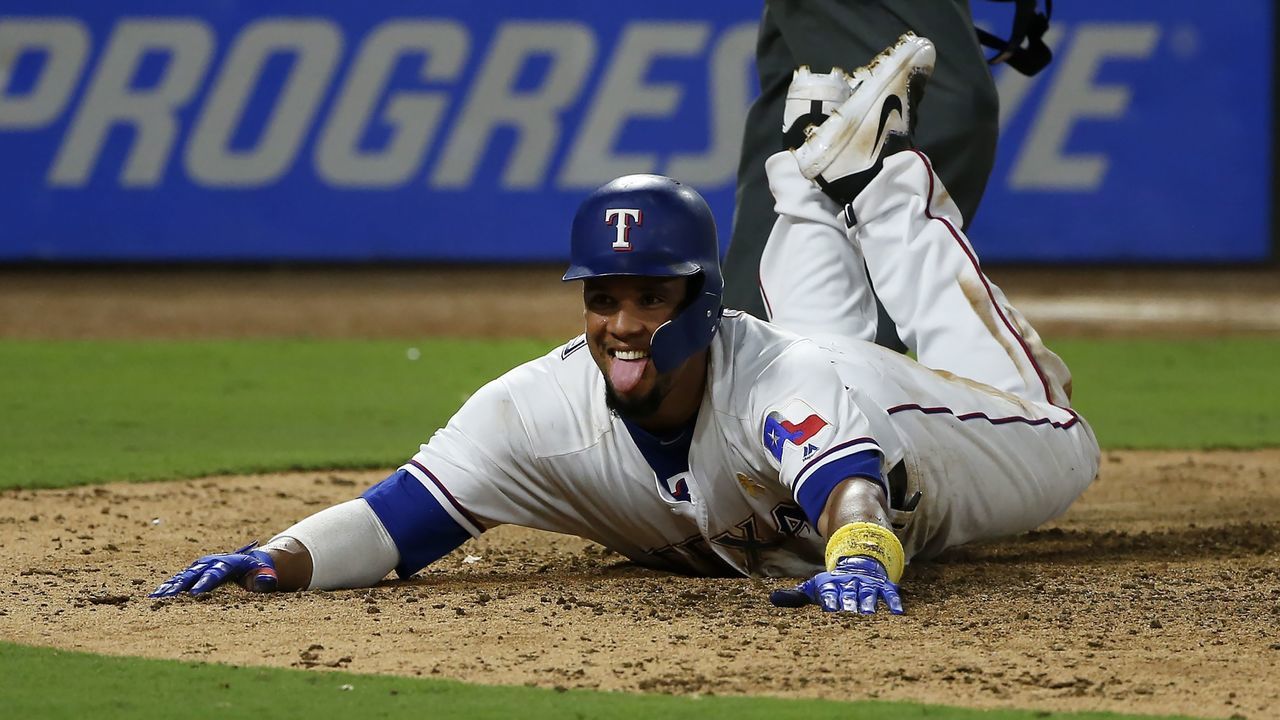 ARLINGTON, TX - SEPTEMBER 1: Carlos Gomez #14 of the Texas Rangers steals home on a wild pitch against the Los Angeles Angels of Anaheim during the eighth inning at Globe Life Park in Arlington on September 1, 2017 in Arlington, Texas.