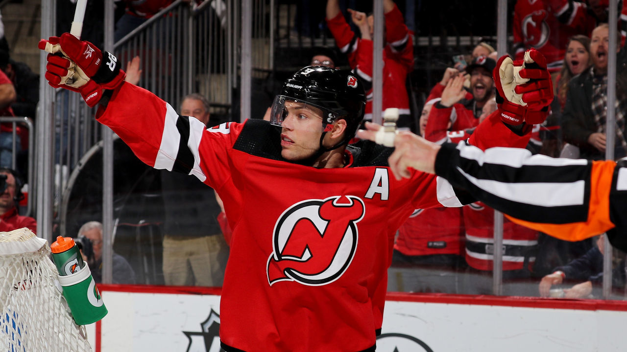 NEWARK, NJ - FEBRUARY 15: Taylor Hall #9 of the New Jersey Devils celebrates teammate Kyle Palmieri's goal in the second period against the Carolina Hurricanes on February 15, 2018 at Prudential Center in Newark, New Jersey.