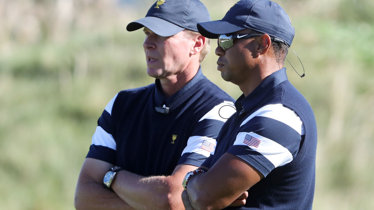 JERSEY CITY, NJ - SEPTEMBER 28: Captain's assistant Tiger Woods and Captain Steve Stricker of the U.S. Team talk during Thursday foursome matches of the Presidents Cup at Liberty National Golf Club on September 28, 2017 in Jersey City, New Jersey.