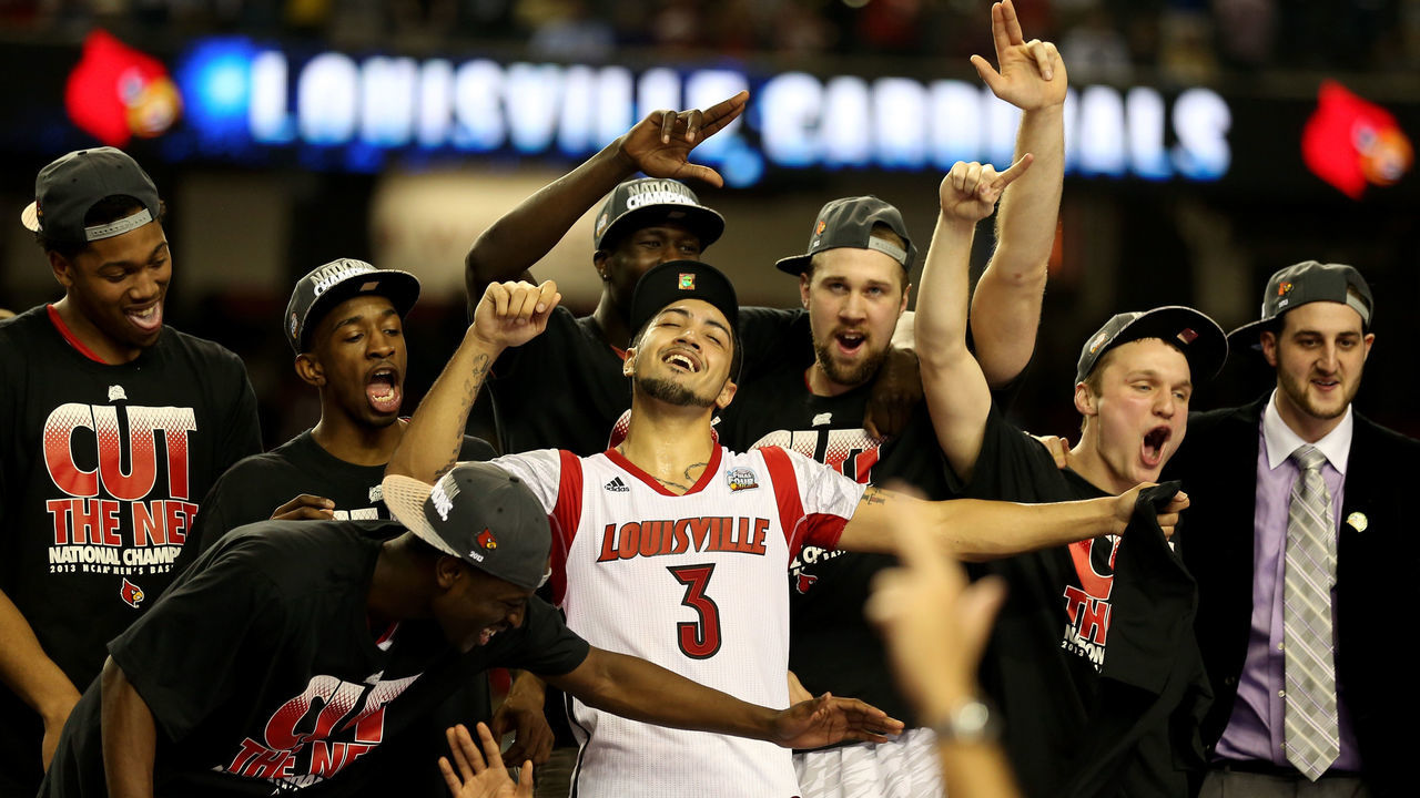 ATLANTA, GA - APRIL 08: Peyton Siva (C) #3 and RUss Smith #2 (L of Siva) of the Louisville Cardinals celebrate with teammates after they defeated the Michigan Wolverines during the 2013 NCAA Men's Final Four Championship at the Georgia Dome on April 8, 2013 in Atlanta, Georgia.