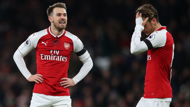 LONDON, ENGLAND - NOVEMBER 29: Aaron Ramsey of Arsenal and Mesut Ozil of Arsenal during the Premier League match between Arsenal and Huddersfield Town at Emirates Stadium on November 29, 2017 in London, England.