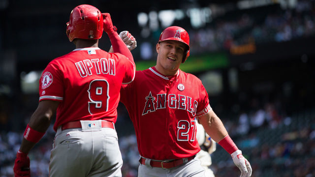 SEATTLE, WA - SEPTEMBER 10: Mike Trout #27 of the Los Angeles Angels of Anaheim celebrates his solo home run in the first inning with Justin Upton #9 against the Seattle Mariners at Safeco Field on September 10, 2017 in Seattle, Washington.