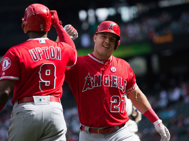 SEATTLE, WA - SEPTEMBER 10: Mike Trout #27 of the Los Angeles Angels of Anaheim celebrates his solo home run in the first inning with Justin Upton #9 against the Seattle Mariners at Safeco Field on September 10, 2017 in Seattle, Washington.