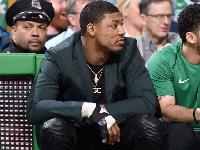 BOSTON, MA - JANUARY 31: Marcus Smart #36 of the Boston Celtics sits courtside during the game against the New York Knicks on January 31, 2018 at the TD Garden in Boston, Massachusetts. Mandatory Copyright Notice: Copyright 2018 NBAE
