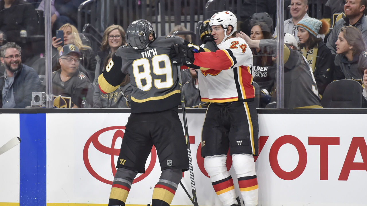 LAS VEGAS, NV - FEBRUARY 21: Alex Tuch #89 of the Vegas Golden Knights and Travis Hamonic #24 of the Calgary Flames shove each other during the game at T-Mobile Arena on February 21, 2018 in Las Vegas, Nevada.