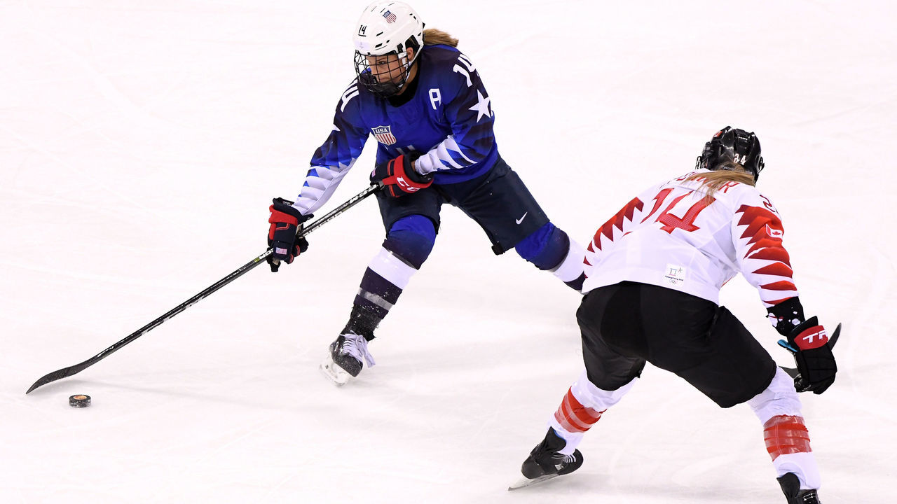 GANGNEUNG, SOUTH KOREA - FEBRUARY 22: Brianna Decker #14 of the United States controls the puck against Renata Fast #14 of Canada in the second period during the Women's Gold Medal Game on day thirteen of the PyeongChang 2018 Winter Olympic Games at Gangneung Hockey Centre on February 22, 2018 in Gangneung, South Korea.