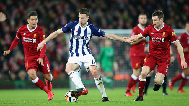 LIVERPOOL, ENGLAND - JANUARY 27: Jonny Evans of West Bromwich Albion holds off James Milner of Liverpool during The Emirates FA Cup Fourth Round match between Liverpool and West Bromwich Albion at Anfield on January 27, 2018 in Liverpool, England.