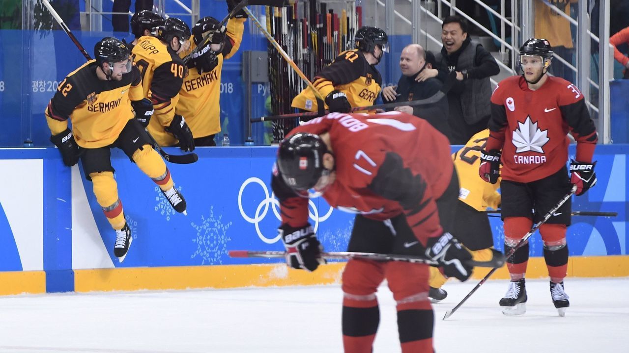 Germany (L) celebrates after winning the men's semi-final ice hockey match between Canada and Germany during the Pyeongchang 2018 Winter Olympic Games at the Gangneung Hockey Centre in Gangneung on February 23, 2018. / AFP PHOTO / JUNG Yeon-Je
