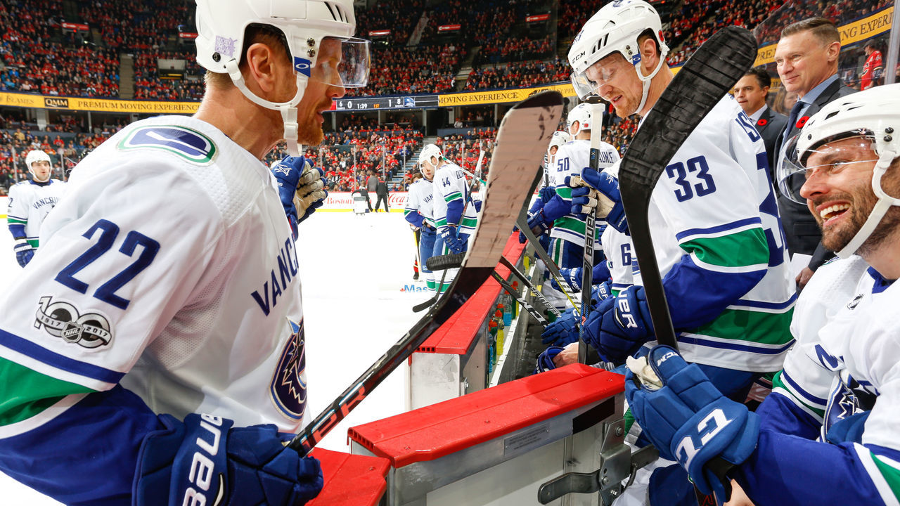 CALGARY, AB - NOVEMBER 7: Daniel Sedin #22 and Thomas Vanek #26 chat in an NHL game against the Calgary Flames at the Scotiabank Saddledome on November 7, 2017 in Calgary, Alberta, Canada.