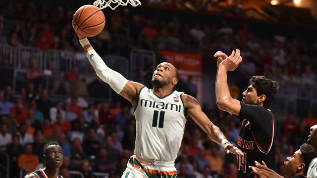 MIAMI, FL - JANUARY 24: Bruce Brown Jr. #11 of the Miami Hurricanes drives to the basket while being defended by Anas Mahmoud #14 of the Louisville Cardinals during the second half of the game at The Watsco Center on January 24, 2018 in Miami, Florida.