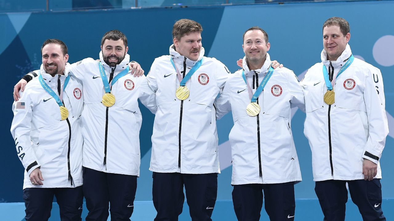 Team USA celebrates on the podium after winning curling men's gold medal game between the USA and Sweden during the Pyeongchang 2018 Winter Olympic Games at the Gangneung Curling Centre in Gangneung on February 24, 2018. / AFP PHOTO / WANG Zhao