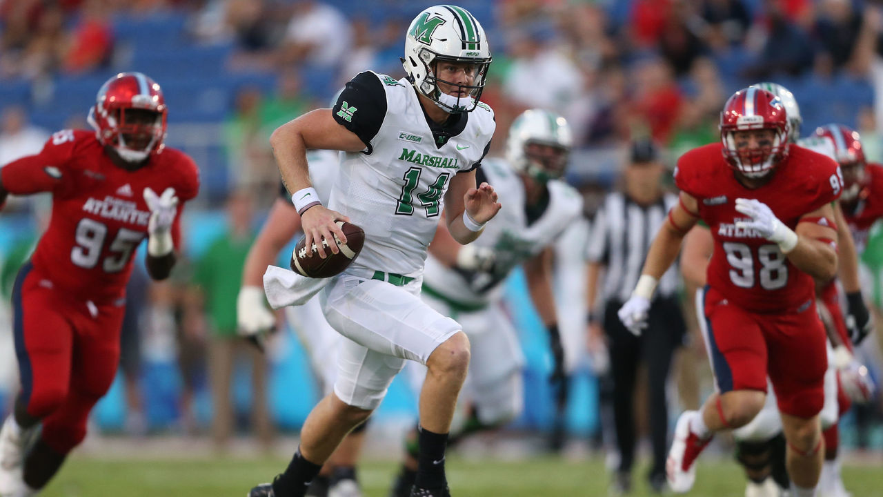 BOCA RATON, FL - NOVEMBER 3: Chase Litton #14 of the Marshall Thundering Herd scrambles out of the pocket during first quarter action against the Florida Atlantic Owls at FAU Stadium on November 3, 2017 in Boca Raton, Florida.