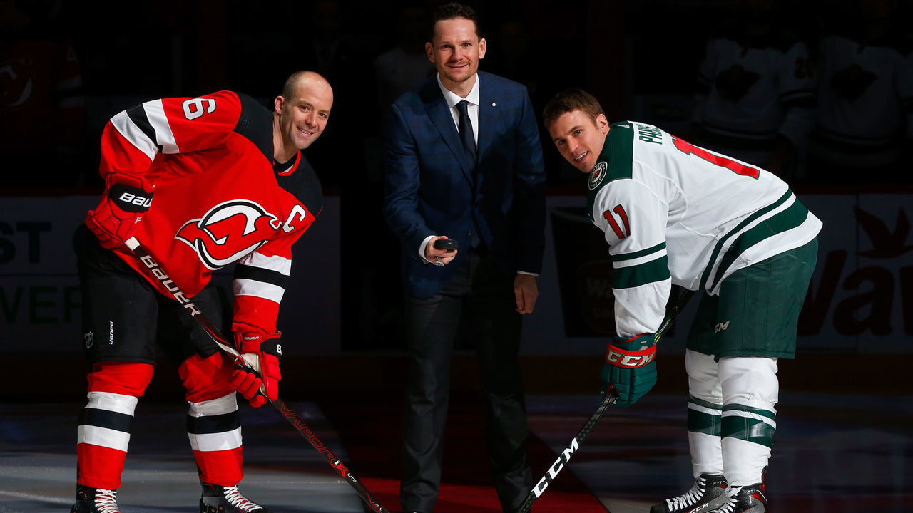 NEWARK, NJ - FEBRUARY 22: Former New Jersey Devil Patrik Elias drops the ceremonial first puck between Andy Greene #6 and Zach Parise #11 of the Minnesota Wild prior to their game on February 22, 2018 at Prudential Center in Newark, New Jersey.