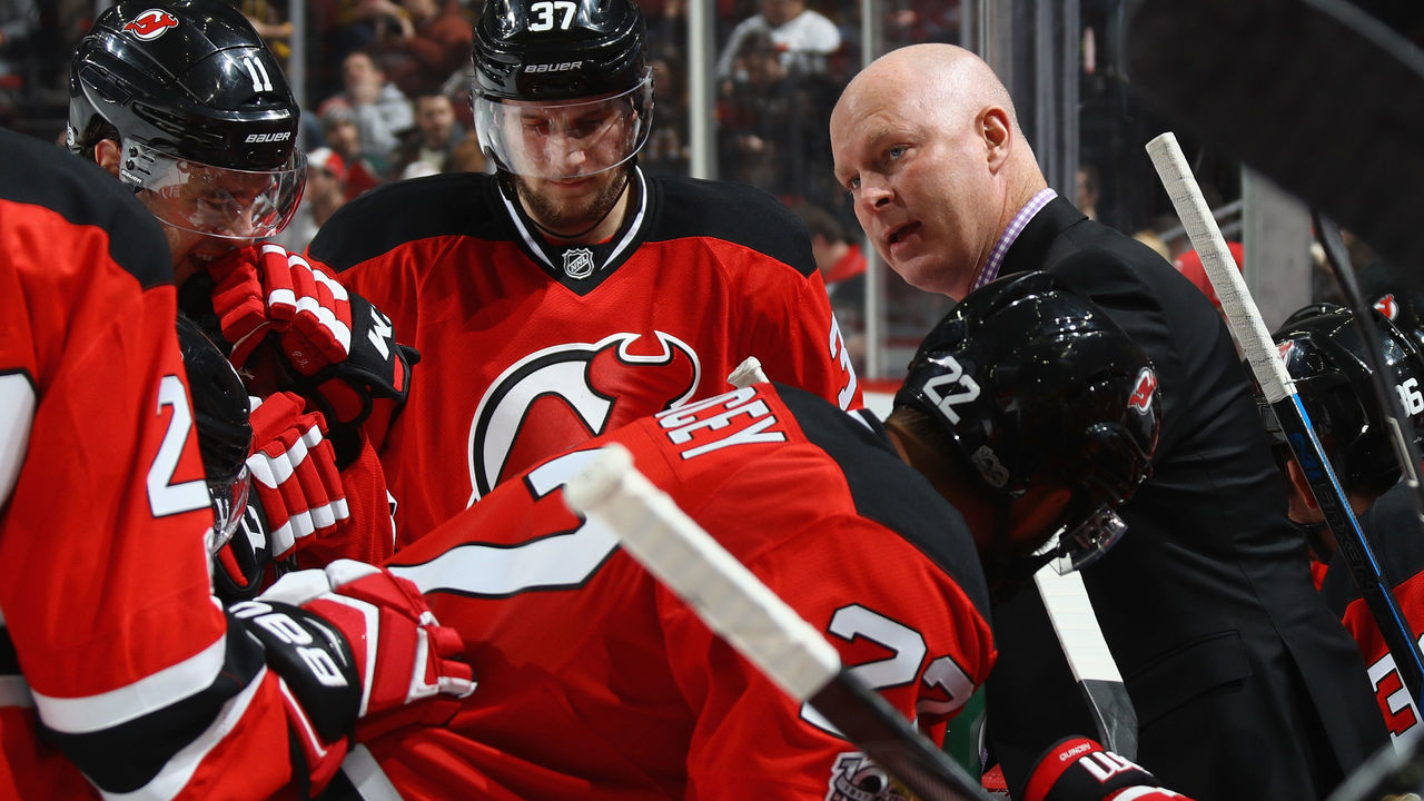 NEWARK, NJ - JANUARY 02: Head coach John Hynes of the New Jersey Devils speaks with players during a second period timeout during the game against the Boston Bruins at the Prudential Center on January 2, 2017 in Newark, New Jersey.