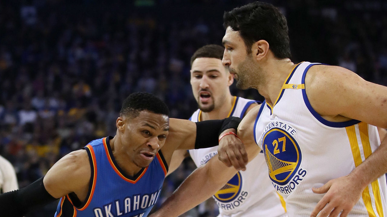 OAKLAND, CA - JANUARY 18: Russell Westbrook #0 of the Oklahoma City Thunder drives on Zaza Pachulia #27 and Klay Thompson #11 of the Golden State Warriors at ORACLE Arena on January 18, 2017 in Oakland, California.