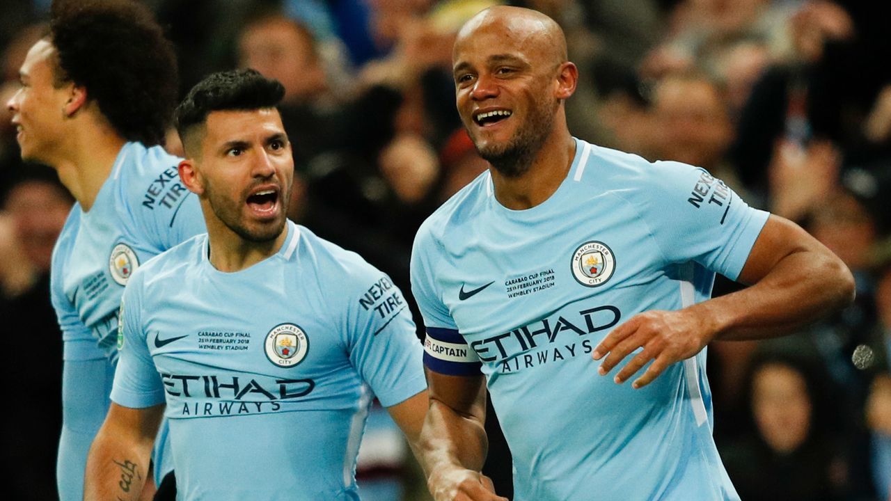 Manchester City's Belgian defender Vincent Kompany (R) celebrates after scoring their second goal during the English League Cup final football match between Manchester City and Arsenal at Wembley stadium in north London on February 25, 2018. / AFP PHOTO / Adrian DENNIS /