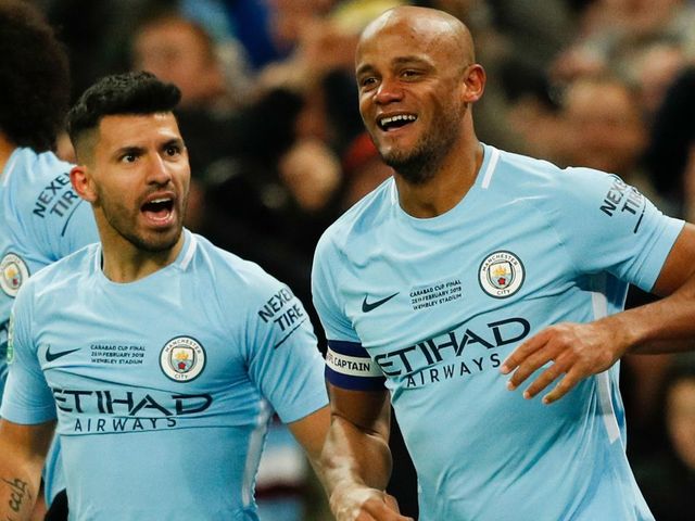 Manchester City's Belgian defender Vincent Kompany (R) celebrates after scoring their second goal during the English League Cup final football match between Manchester City and Arsenal at Wembley stadium in north London on February 25, 2018. / AFP PHOTO / Adrian DENNIS /