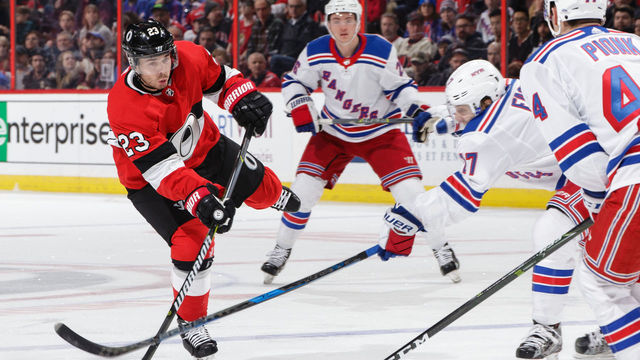 OTTAWA, ON - FEBRUARY 17: Nick Shore #23 of the Ottawa Senators shoots the puck as Jesper Fast #17 of the New York Rangers makes a stick check in the second period at Canadian Tire Centre on February 17, 2018 in Ottawa, Ontario, Canada.