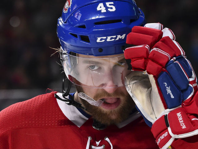 MONTREAL, QC - JANUARY 07: Joe Morrow #45 of the Montreal Canadiens adjusts his visor against the Vancouver Canucks during the NHL game at the Bell Centre on January 7, 2018 in Montreal, Quebec, Canada. The Montreal Canadiens defeated the Vancouver Canucks 5-2.
