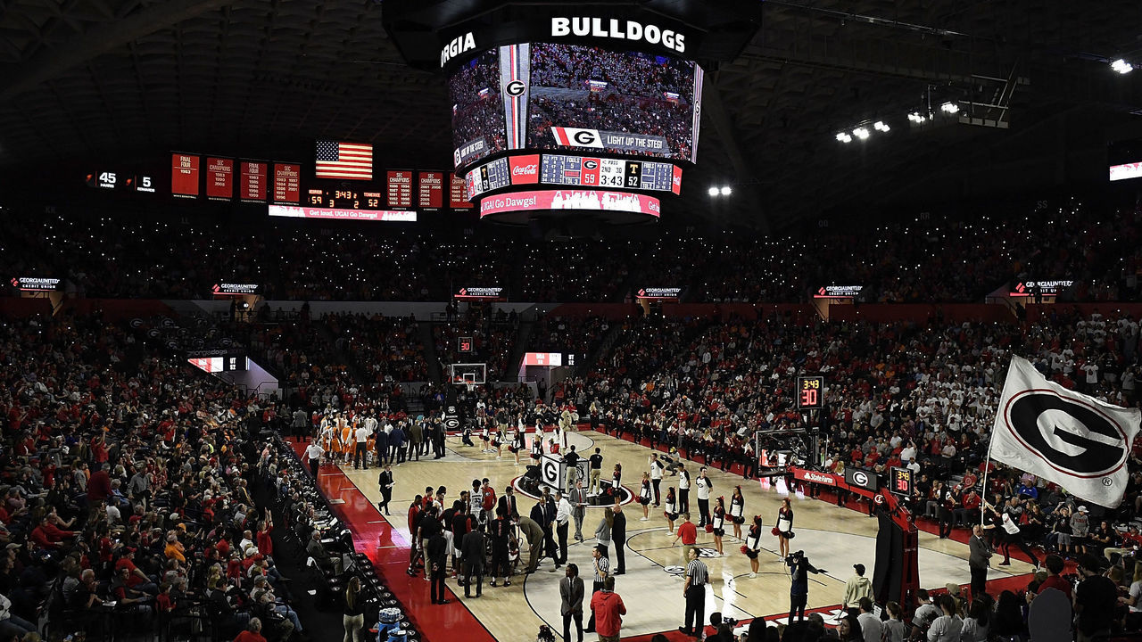 ATHENS, GA - FEBRUARY 17: Fans shine lights on their phones as a UGA flag is run onto the floor during a stoppage in play of the Tennessee Volunteers' basketball game against the Georgia Bulldogs at Stegeman Coliseum on February 17, 2018 in Athens, Georgia.