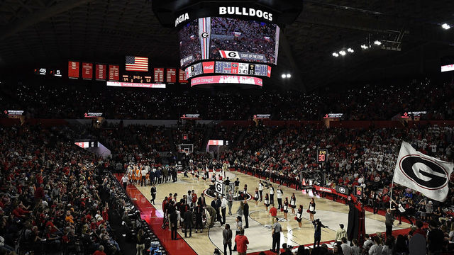 ATHENS, GA - FEBRUARY 17: Fans shine lights on their phones as a UGA flag is run onto the floor during a stoppage in play of the Tennessee Volunteers' basketball game against the Georgia Bulldogs at Stegeman Coliseum on February 17, 2018 in Athens, Georgia.