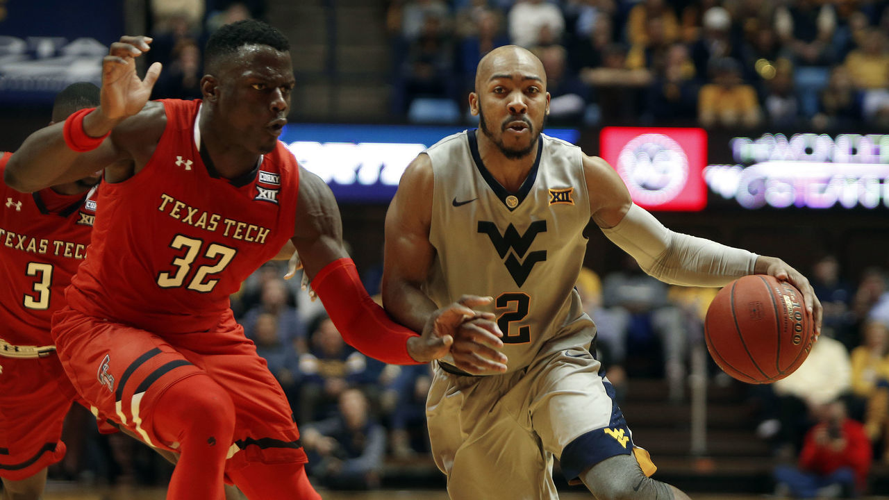 MORGANTOWN, WV - FEBRUARY 26: Jevon Carter #2 of the West Virginia Mountaineers brings the ball down court against Norense Odiase #32 of the Texas Tech Red Raiders at the WVU Coliseum on February 26, 2018 in Morgantown, West Virginia.
