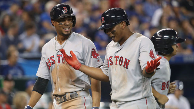 TORONTO, ON - AUGUST 30: Xander Bogaerts #2 of the Boston Red Sox celebrates with Rafael Devers #11 after both scored on a single by Mitch Moreland in the eighth inning during MLB game action against the Toronto Blue Jays at Rogers Centre on August 30, 2017 in Toronto, Canada.