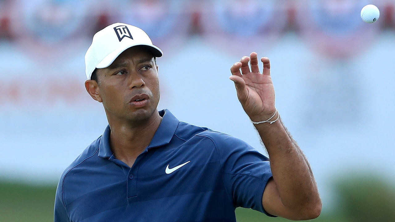 PALM BEACH GARDENS, FL - FEBRUARY 24: Tiger Woods catches a ball on the 17th hole during the third round of The Honda Classic at PGA National Resort and Spa on February 24, 2018 in Palm Beach Gardens, Florida.