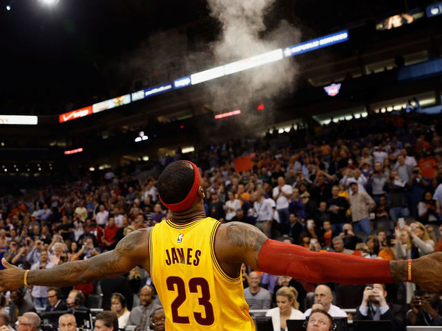 PHOENIX, AZ - JANUARY 13: LeBron James #23 of the Cleveland Cavaliers throws powder into the air before the start of the NBA game against the Phoenix Suns at US Airways Center on January 13, 2015 in Phoenix, Arizona. The Suns defeated the Cavaliers 107-100.