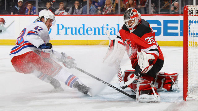 NEWARK, NJ - DECEMBER 21: Cory Schneider #35 of the New Jersey Devils makes the first period save on Brendan Smith #42 of the New York Rangers at the Prudential Center on December 21, 2017 in Newark, New Jersey.