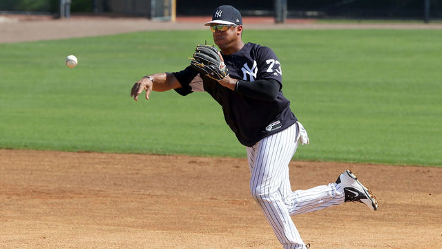 TAMPA, FL - MAR 01: Russell Wilson (73) makes the throw over to first base to complete the double play during the New York Yankees spring training workout on March 01, 2018, at George M. Steinbrenner Field in Tampa, FL. Wilson, who is the Seattle Seahawks starting quarterback is in Yankees camp working out with the major league team.