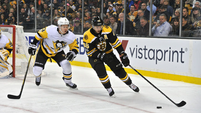 BOSTON, MA - NOVEMBER 18: Boston Bruins Center David Krejci (46) gets control of the loose puck ahead of Pittsburgh Penguins Defenceman Olli Maatta (3). During the Boston Bruins game against the Pittsburgh Penguins on November 24, 2017 at TD Bank Garden in Boston, MA.
