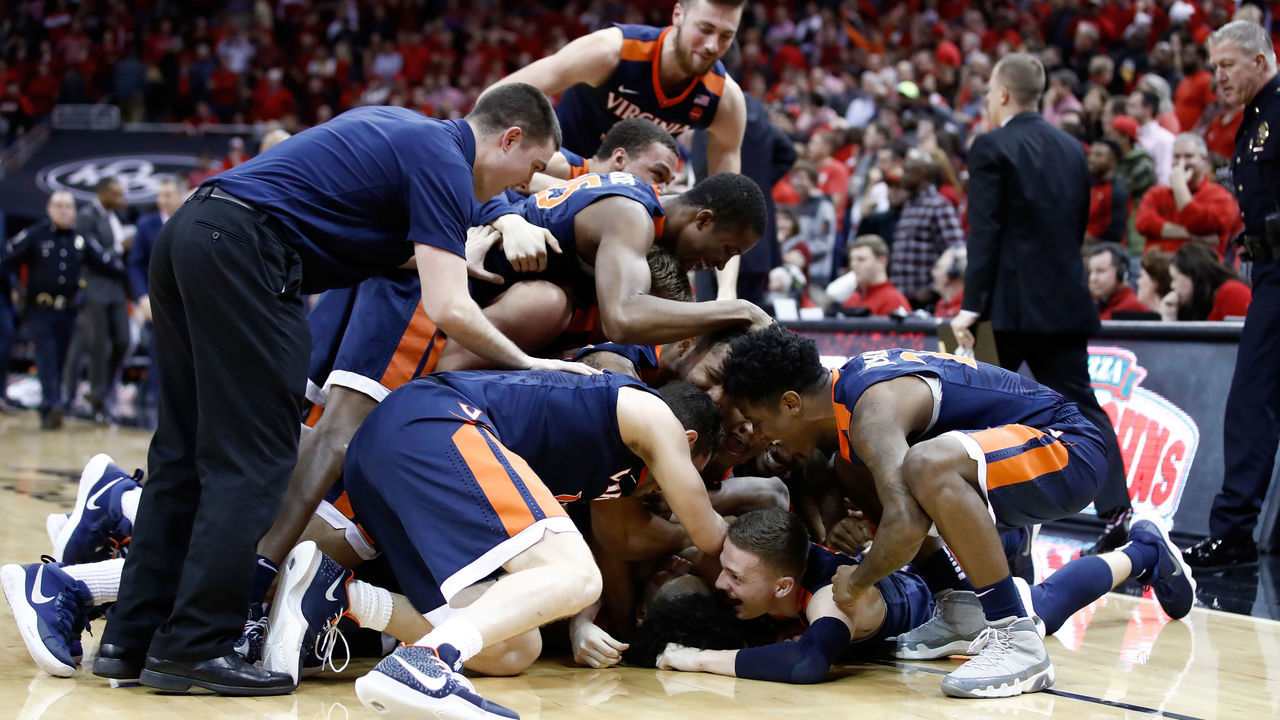LOUISVILLE, KY - MARCH 01: The Virginia Cavaliers mob De'Andre Hunter #12 after hunter made a three point shot at the buzzer to beat the Louisville Cardinals 67-66 at KFC YUM! Center on March 1, 2018 in Louisville, Kentucky.