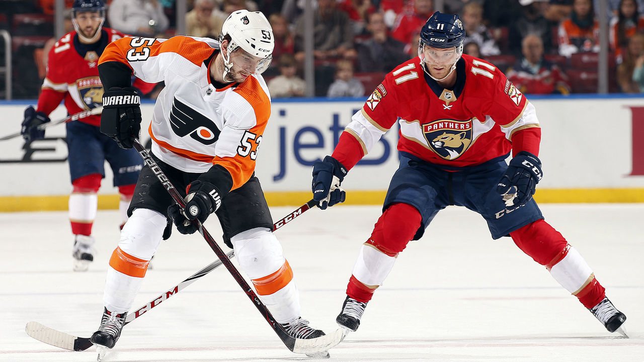 SUNRISE, FL - DECEMBER 28: Shayne Gostisbehere #53 of the Philadelphia Flyers skates with the puck against Jonathan Huberdeau #11 of the Florida Panthers at the BB&T Center on December 28, 2017 in Sunrise, Florida.