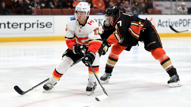 ANAHEIM, CA - DECEMBER 29: Johnny Gaudreau #13 of the Calgary Flames skates past Hampus Lindholm #47 of the Anaheim Ducks during the second period of a game at Honda Center on December 29, 2017 in Anaheim, California.