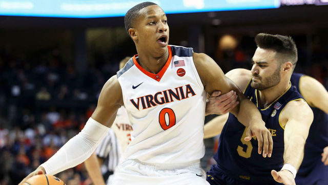 CHARLOTTESVILLE, VA - MARCH 3: Devon Hall #0 of the Virginia Cavaliers drives through Matt Farrell #5 of the Notre Dame Fighting Irish in the first half during a game at John Paul Jones Arena on March 3, 2018 in Charlottesville, Virginia.