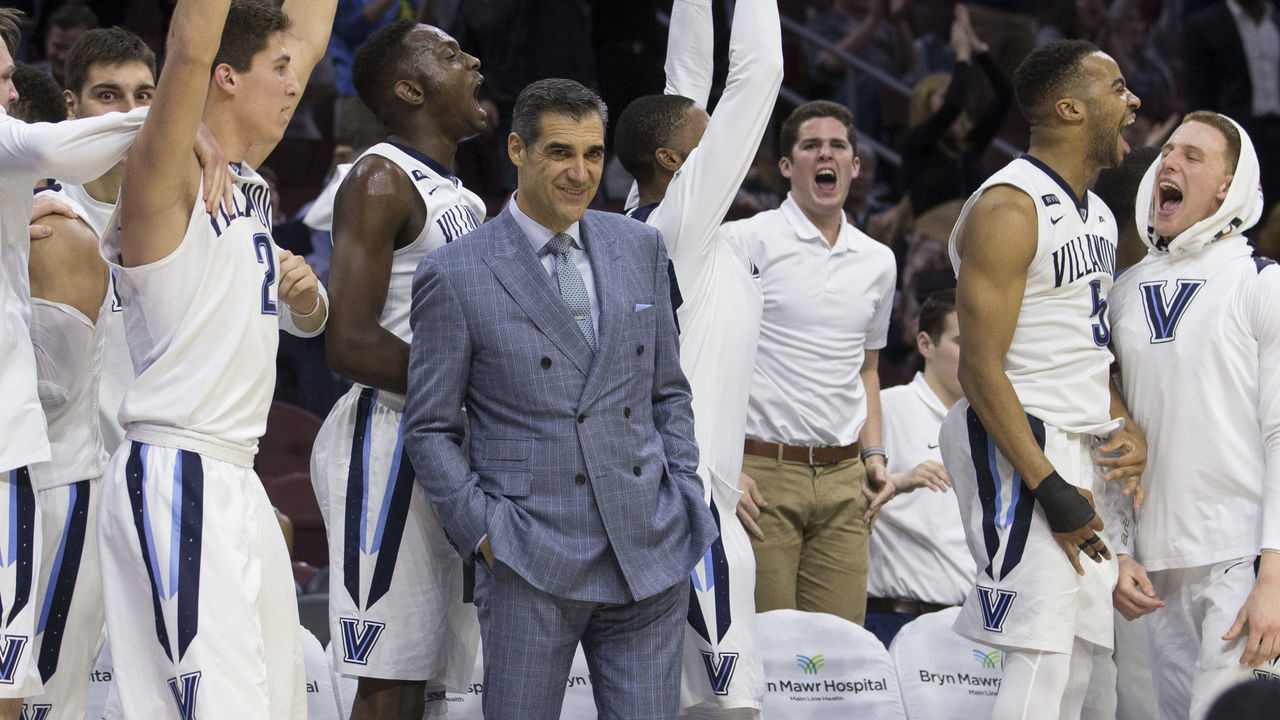 PHILADELPHIA, PA - FEBRUARY 21: Head coach Jay Wright of the Villanova Wildcats smiles from the bench while Collin Gillespie #2, Dhamir Cosby-Roundtree #21, Phil Booth #5 and Donte DiVincenzo #10 celebrate after a three point basket made by Denny Grace in the second half against the DePaul Blue Demons at the Wells Fargo Center on February 21, 2018 in Philadelphia, Pennsylvania. The Villanova Wildcats defeated the DePaul Blue Demons 93-62.