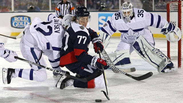 ANNAPOLIS, MD - MARCH 03: T.J. Oshie #77 of the Washington Capitals skates past Nikita Zaitsev #22 of the Toronto Maple Leafs during the third period in the Coors Light NHL Stadium Series at Navy-Marine Corps Memorial Stadium on March 3, 2018 in Annapolis, Maryland.